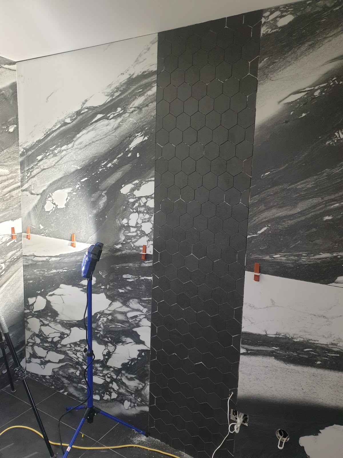 Black marble and hexagonal tile feature wall