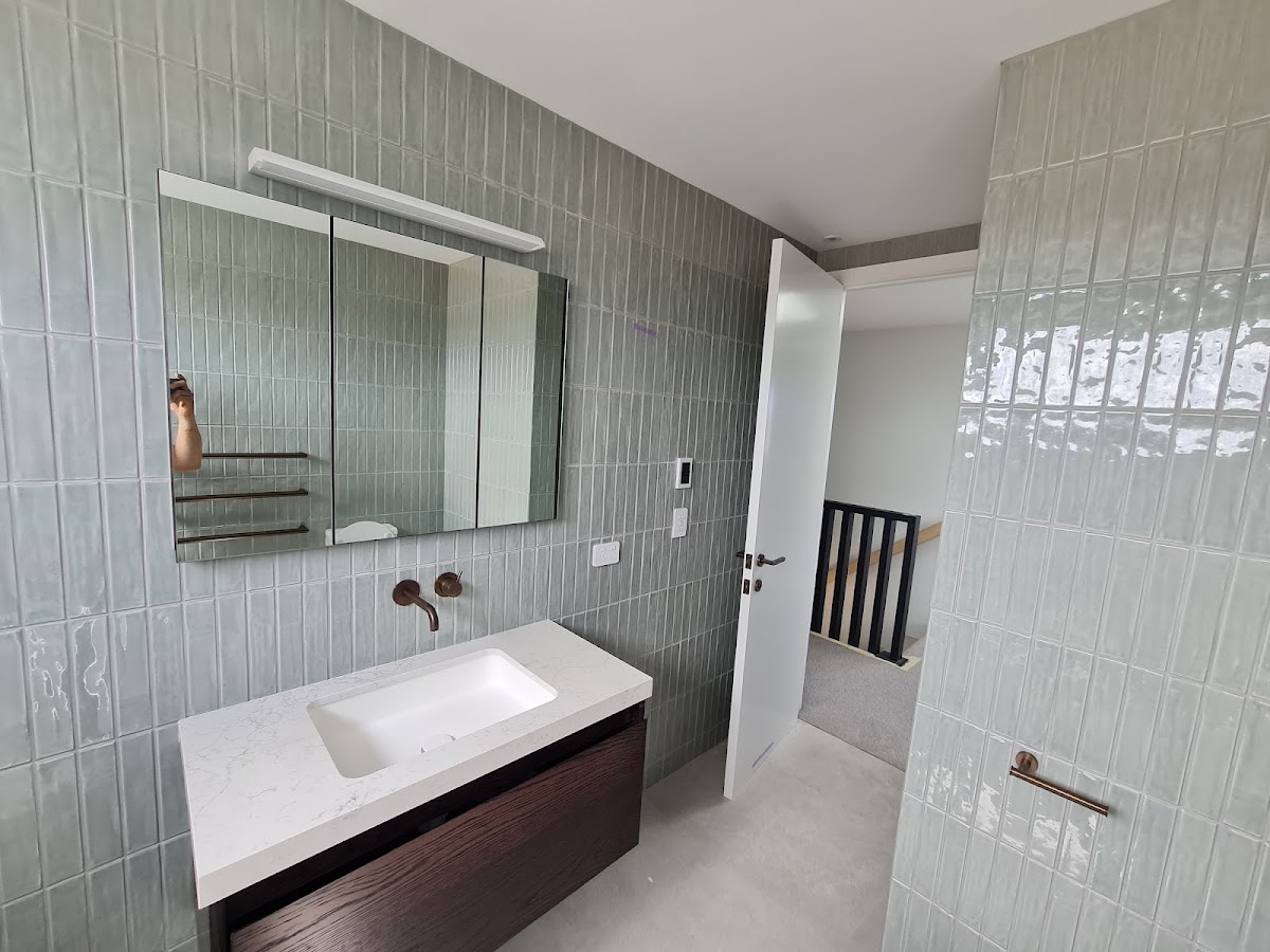 Modern bathroom with sage green subway tiles